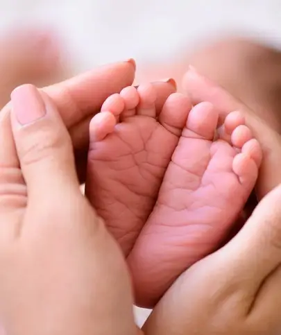 caregiver with baby feet